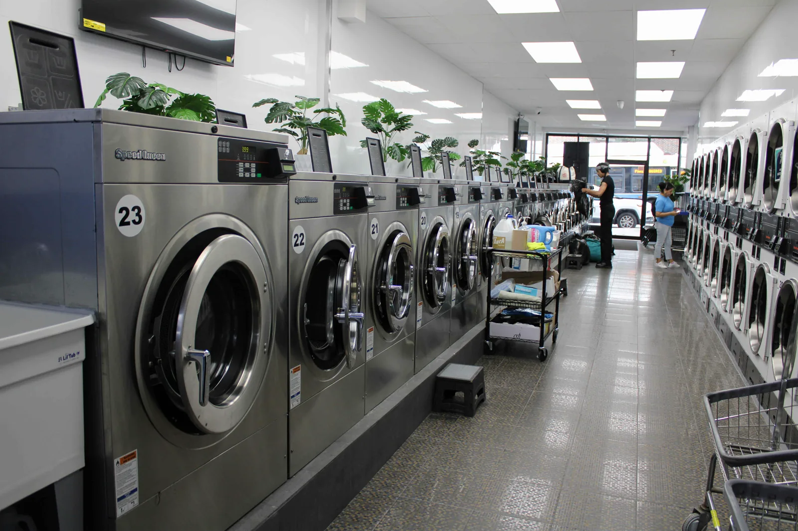 Numbered Speed Queen washers and the front entrance of Neatly at 37 Lincoln Rd in Prospect Lefferts Gardens, the Brooklyn store that handles every pickup order